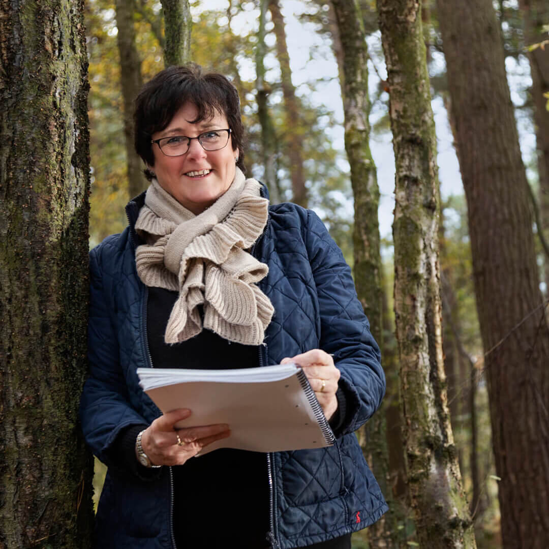 Ruth holding a notebook during autumn